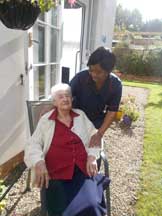 carer with resident in garden
